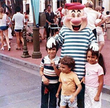 Many couples visit a Disney theme park for a date, but the Toronto Star posted one of the strangest Disney love stories I have ever heard. About 30 years ago, when they lived in separate countries, long before they met and married, a family shot of little Donna Voutsinas at Walt Disney World also happened to catch then 3-year-old Alex Voutsinas in a stroller in the background.